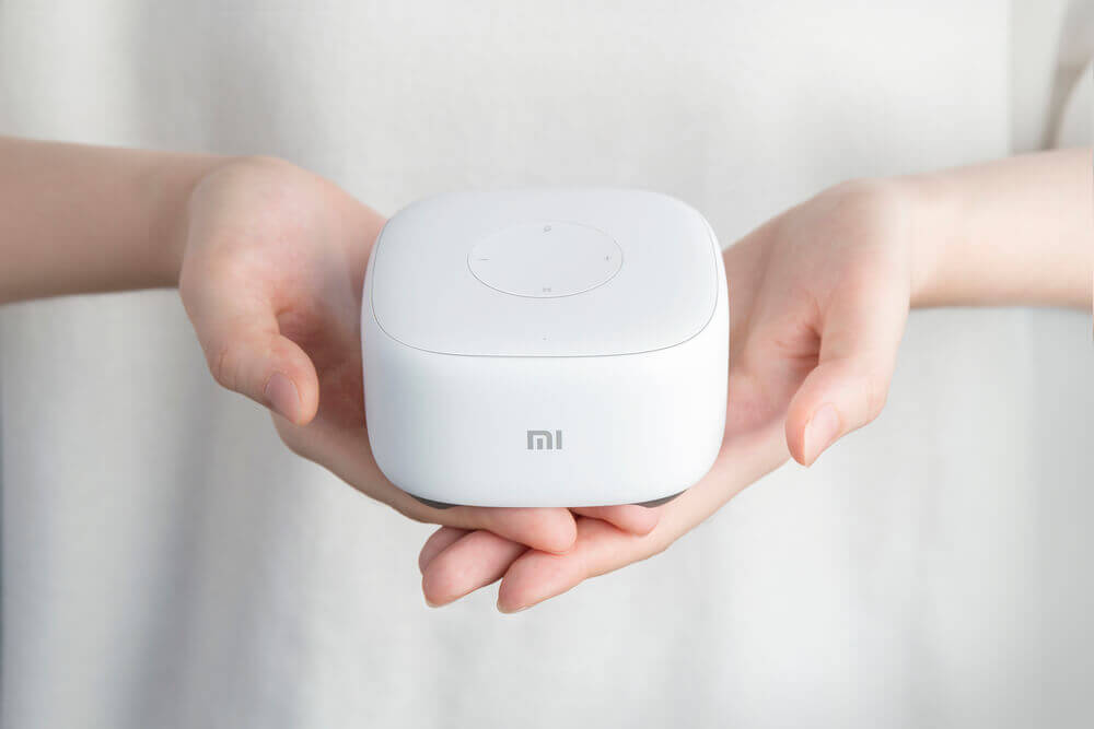 Белая Xiaomi Mi AI Mini Speaker в женских руках